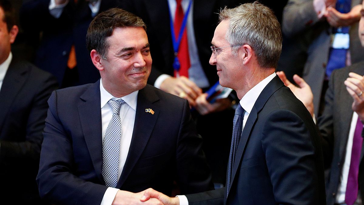 Macedonian FM Dimitrov shakes hands with NATO Secretary General Stoltenberg