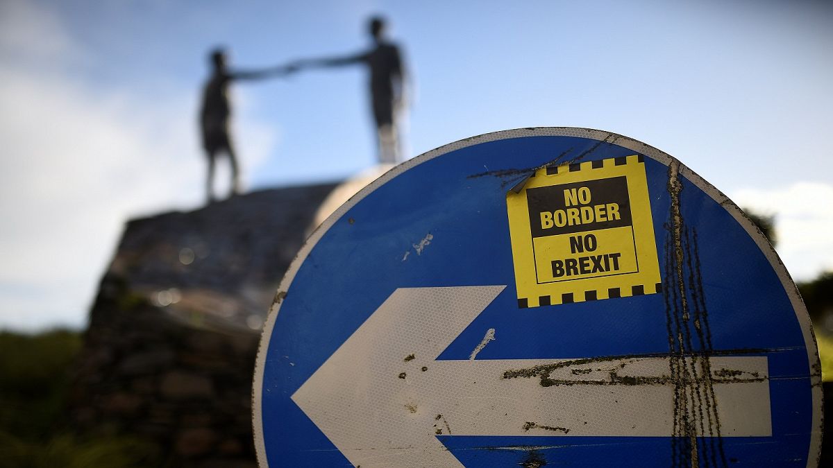 A ' No Border, No Brexit' sticker on a road sign in Londonderry