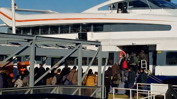 Passengers prepare to board a ferry Passengers prepare to board a ferry