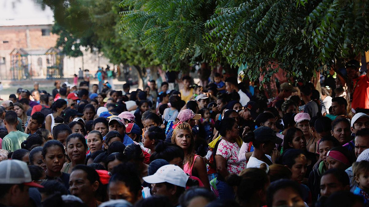 مواطنون فنزويليون ينتظرون للحصول على وجبات غذائية عند مخيم للاجئين 