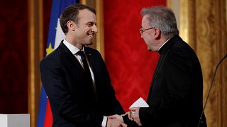 French President Emmanuel Macron and Archbishop Luigi Ventura (R) in 2018.