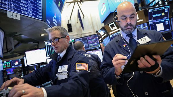 Traders work on the floor of the NYSE in New York Traders work on the floor of the NYSE in New York
