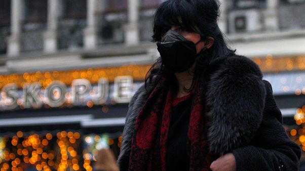 A woman covers her face as air pollution reaches dangerous levels in Skopje A woman covers her face as air pollution reaches dangerous levels in Skopje