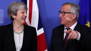 Theresa May and Jean-Claude Juncker share a joke ahead of Brexit talks