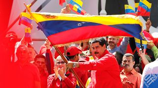 Maduro waves a Venezuelan flag