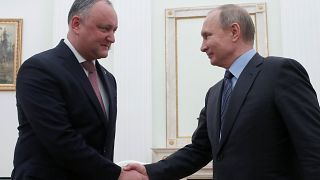 Moldovan president Igor Dodon shakes hands with Vladimir Putin