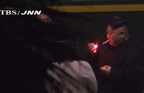 Kim Jong Un smoking at a Chinese Station
