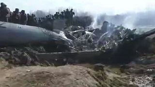 A screengrab of a Reuters video showing a crashed plane in Kashmir