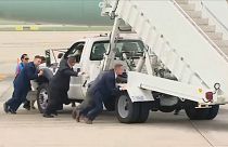Bodyguards push the boarding steps out of the way for Air Force One