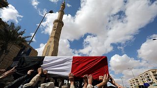 Mourners carry the body of an Egyptian officer killed in Sinai