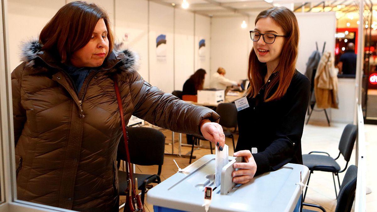 A woman casts her vote during advanced voting in Tallin