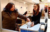 A woman casts her vote during advanced voting in Tallin