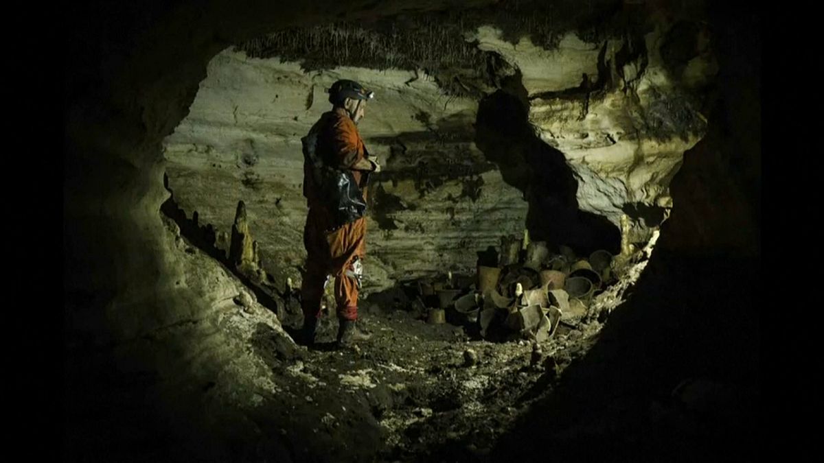 An archaeologist surveys the Balamku cave under Chichen Itza in Mexico