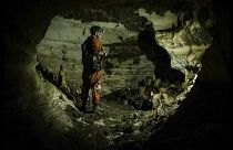 An archaeologist surveys the Balamku cave under Chichen Itza in Mexico
