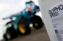File picture: A can of glyphosate weedkiller is seen in front of a tractor