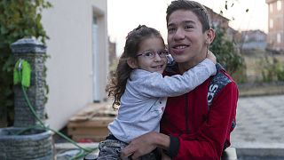 14-year-old Rijad Mehmeti, who has cerebal palsy, with his sister