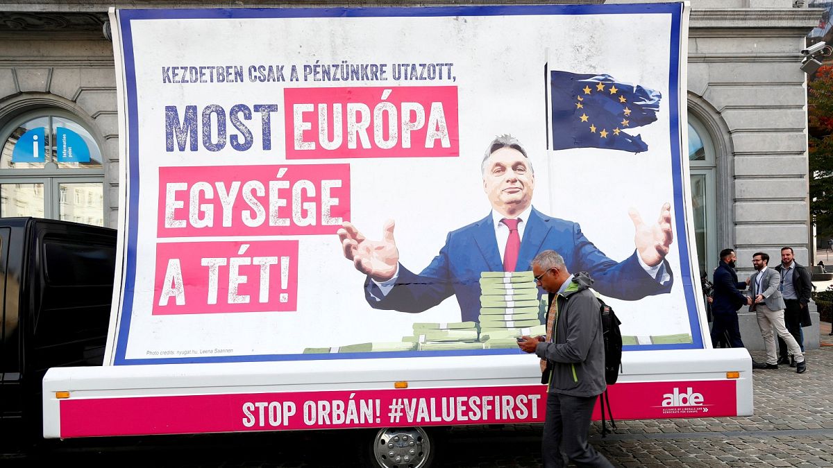 A pedestrian walks past an anti-Hungary's PM Orban billboard in Brussels