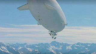 Freeriders abseil onto mountian-top in Austria