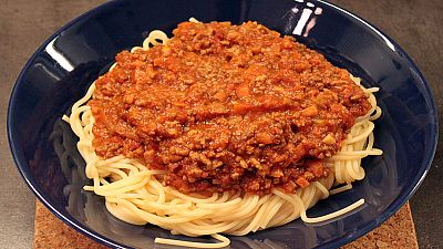 A plate of "spaghetti bolognese", spaghetti topped with a tomato meat sauce