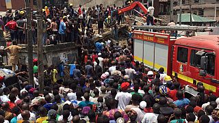 Rescue workers at the site of a collapsed building in Lagos, Nigeria