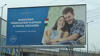 Hungarian government uses couple from 'unfaithful boyfriend meme' in billboard campaign