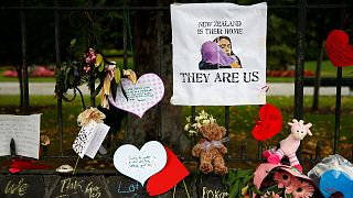Signs at a memorial site for victims of the Christchurch mosque shootings