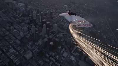 Wingsuits swoop over Los Angeles skyscrapers during supermoon night sky