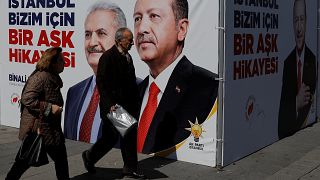 People walk past an AK Party campaign tent, Istanbul, March 2019