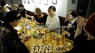Guests attend a dinner with 24 carat gold-covered dishes, 