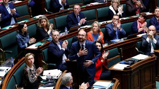 Belgium's Prime Minister Charles Michel reacts after delivering a speech