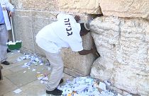 Clean out of written prayers from cracks of Jerusalem's Western Wall