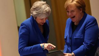 What was on the tablet that had May and Merkel laughing?