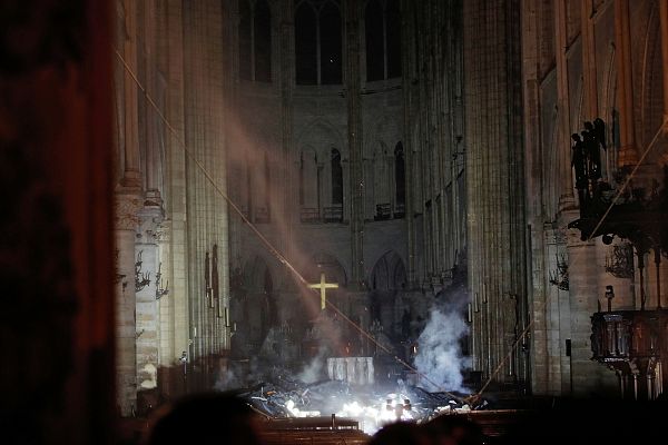 Smoke rises around the altar inside the Notre Dame Cathedral