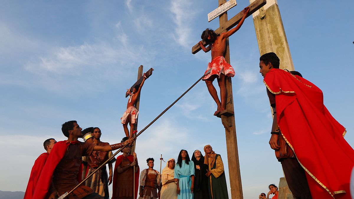 Actors are seen on the cross in a re-enactment of the crucifixion of Jesus 