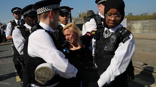 A climate change activist is detained during the London protest