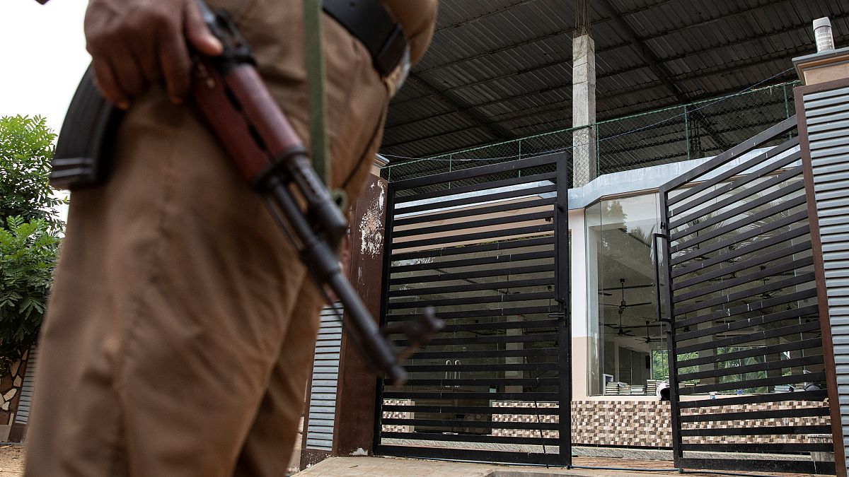 Policeman stands guard outside sealed office of National Tawheed Jamaath