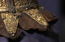 Items unearthed include a golden belt buckle and the remnants of a harp