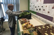 “Sarah Nor,” a volunteer and pantry user at the Goodwin Community Pantry.