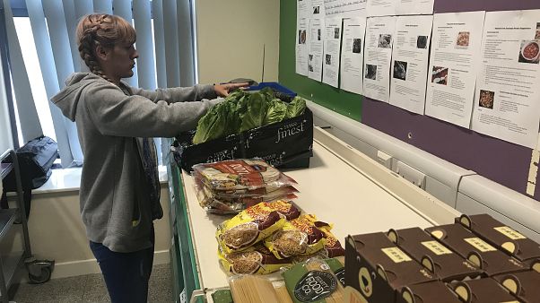 “Sarah Nor,” a volunteer and pantry user at the Goodwin Community Pantry.