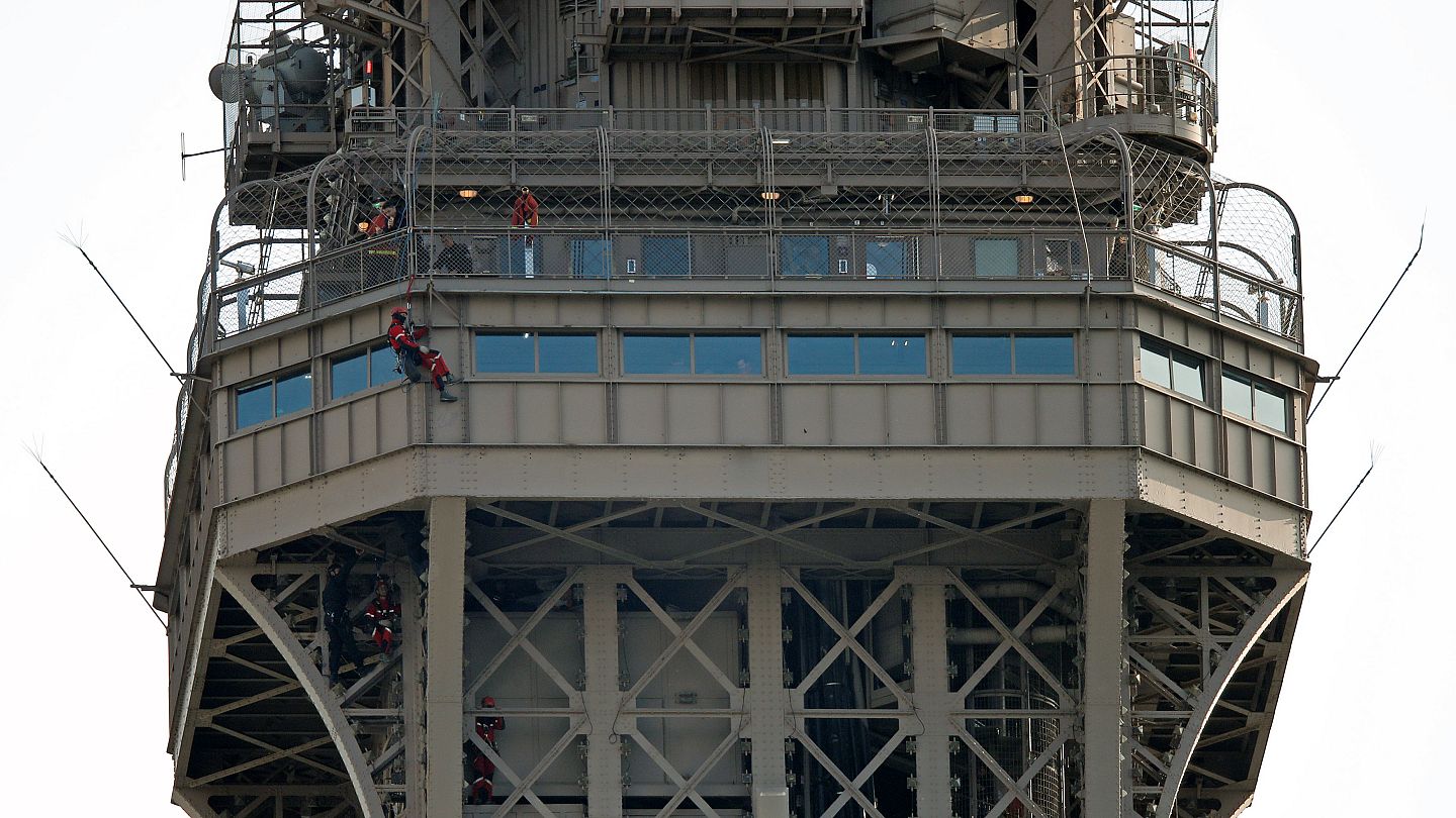 Eiffel Tower evacuated after man climbs on structure | Euronews