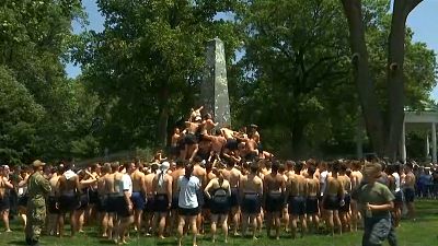 U.S. Naval Academy first-years attempt annual greased climb
