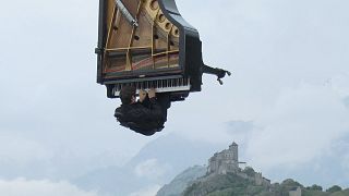 Hitting the high notes: Hanging from a crane, a pianist plays in the air