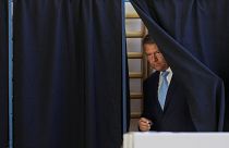 Romanian President Klaus Iohannis leaves a polling booth