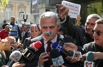 Liviu Dragnea has handcuffs waved in front of him by Romanian protesters