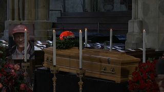 The coffin of the three-time champion was decorated with his racing helmet