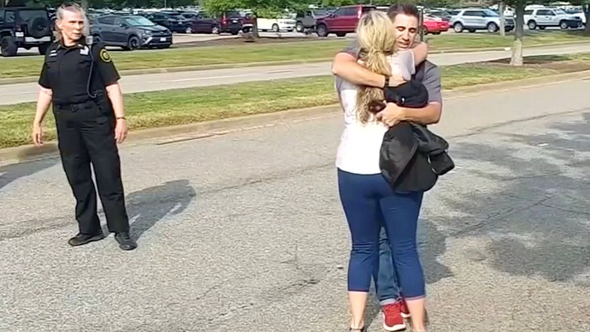 Survivors and witnesses embrace after the Virginia Beach shooting