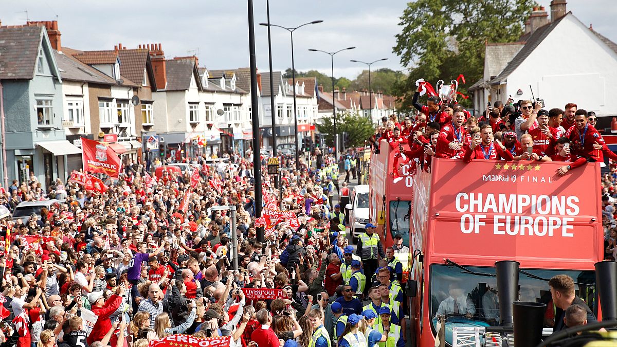 Liverpool's team bus travels past fans during the parade 