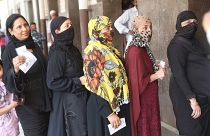 Indiai nők várakoznak egy szavazóhelyiség előtt Újdelhiben