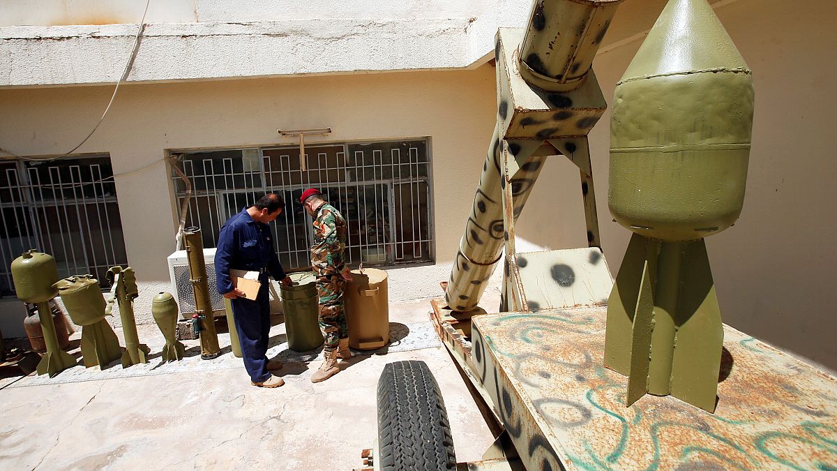 عناصر من البيشمركة يتفقدون أسلحة كانت بحوزة الدولة الإسلامية 