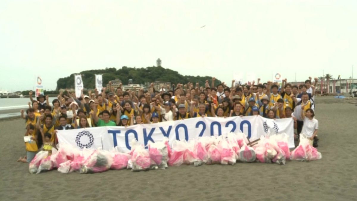 Teams compete to pick up trash on Tokyo 2020 Olympic beach